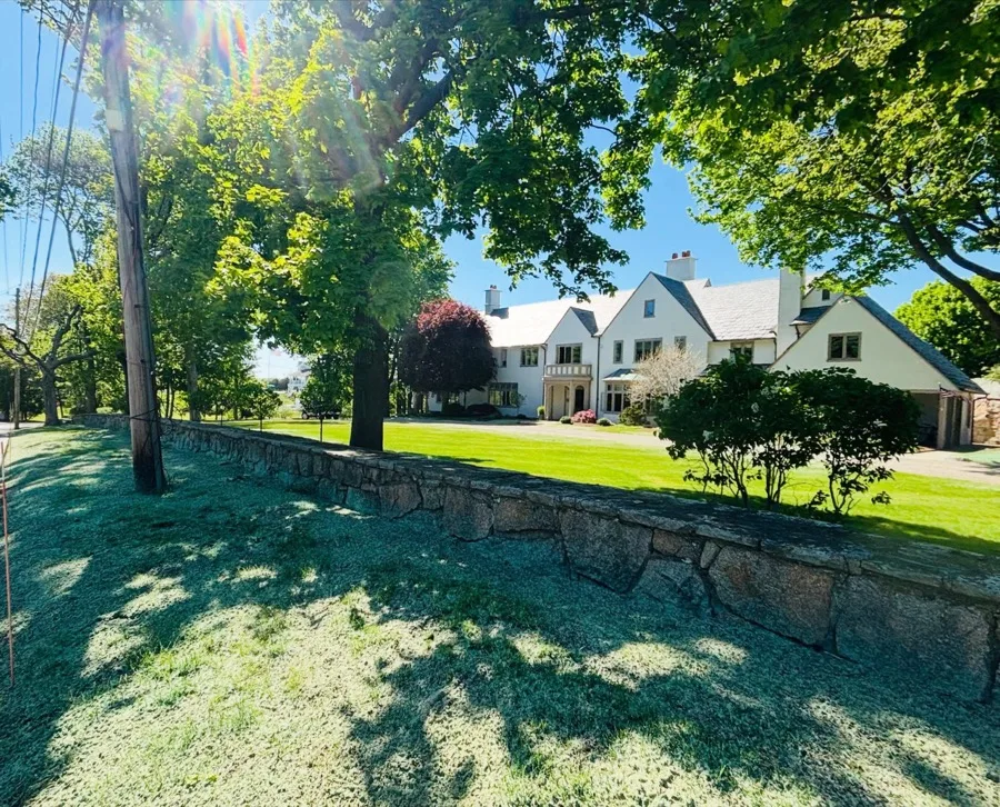 Minot property restoration with new stone wall and lawn installation